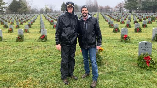 Kevin Murphy and his dad standing in front of a cemetery with freshly laid wreaths