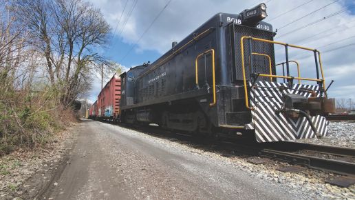 train engine on tracks hauling freight