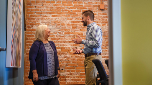 Kevin Murphy talks with Cheryl Irwin-Bass in a conference room at Scheffey